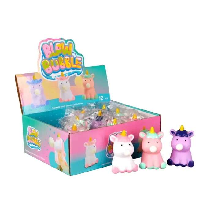 Display box of 'Blow Bubble' squishy toys, featuring unicorn-shaped figures in various pastel colors. The box contains individually wrapped squishy toys, with three unicorns shown in front: one white with pink accents, one pink with mint green accents, and one purple with dark blue accents.