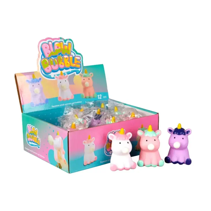 Display box of 'Blow Bubble' squishy toys, featuring unicorn-shaped figures in various pastel colors. The box contains individually wrapped squishy toys, with three unicorns shown in front: one white with pink accents, one pink with mint green accents, and one purple with dark blue accents.