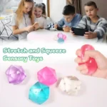 Masonry Ice Squishy Stress Ball in pink, blue, purple, and orange translucent colours, individually boxed and displayed in a retail countertop display.