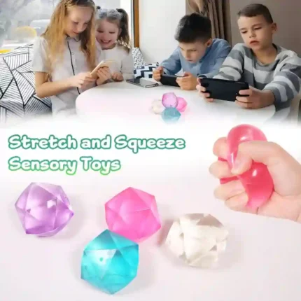 Masonry Ice Squishy Stress Ball in pink, blue, purple, and orange translucent colours, individually boxed and displayed in a retail countertop display.