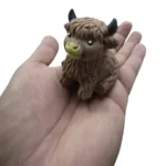 Crunchy Hallow Cow Highland cow squishy toy with shaggy brown texture, yellow muzzle, black horns and 12-piece wholesale display by SDMAX Toys Wholesaler.