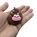 Brady Bubeey brown poop-shaped squishy toy with pink smile, individual packaging and 12-piece wholesale display by SDMAX Toys Wholesaler.