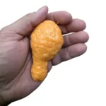 Crunchy orange fried chicken leg squishy toy measuring approximately 9 × 5 cm, displayed in a 12-piece wholesale box by SDMAX Toys Wholesaler.