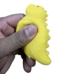 Crunchy Dino Squishy Toy in yellow and green, 7 × 8 cm, displayed in a 12-piece wholesale box by SDMAX Toys Wholesaler.