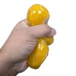 Buy Squish Crush Bear Coconut Oil Squishy Toys wholesale from SDMAX. Glittery bear design, 14 × 6 cm, 12 pieces per box. Ideal for retailers and resellers.