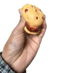 Crunchy Cream Cookie Squishy Toy featuring a golden cookie with chocolate chip details, individual clear packaging and a 12-piece wholesale display box from SDMAX Toys Wholesaler.