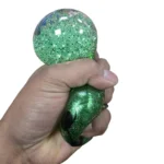 Grinch Mystery Dumplings Squishy Toy wholesale display box with green glitter-effect character toys, 12 per box, approximately 8.5cm, £2.25 each, from SDMAX Toys Wholesaler.
