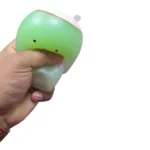 Green Matcha Squish-Tea strawberry scented squishy toy with pink lid, smiling face, retail packaging and wholesale box of 12 from SDMAX Toys Wholesaler.