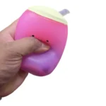 Boba Squish-Tea pink and purple vanilla scented squishy toy with smiling bubble tea design, retail packaging and wholesale box of 12 from SDMAX Toys Wholesaler.