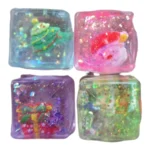 Christmas Glitter Jelly Sugar Maltose Cube Squishy Toys in assorted colours with glitter, Christmas display boxes, £3.25 each and 12 pieces per box from SDMAX Toys Wholesaler.