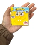 Crunchy Sponge Squishy Toy featuring a yellow square smiling character with large eyes, individual retail packaging and a 12-piece wholesale display box from SDMAX Toys Wholesaler.