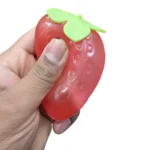 Vaseline Strawberry Squishy Toy in red strawberry design with green leaves, individual retail packaging and 12-piece wholesale display box, priced at £2.75 each by SDMAX Toys Wholesaler.