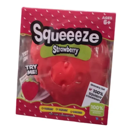 Large red strawberry-shaped squishy squeeze toy with green leaves and textured seed details, approximately 15 × 13cm, shown with retail packaging and wholesale display box of 6.