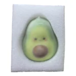 Crispy Avocado Squishy Fidget Toy featuring a cute light green avocado character with a brown centre, individual retail packaging, and a 12-piece wholesale display from SDMAX Toys Wholesaler.