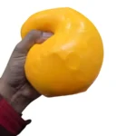 Jumbo yellow Cheese Block Squishy Toy shown in individual retail packaging and a four-piece display box, advertised at £5.50 each, size 11 × 11 cm, from SDMAX Toys Wholesaler.